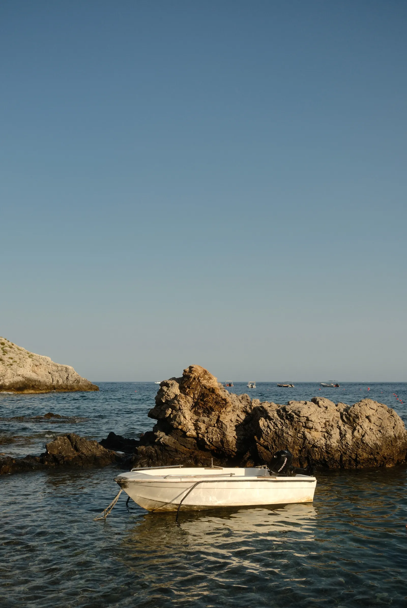 a boat in Isola bella taormina Sicily - Essenza fujifilm film recipe