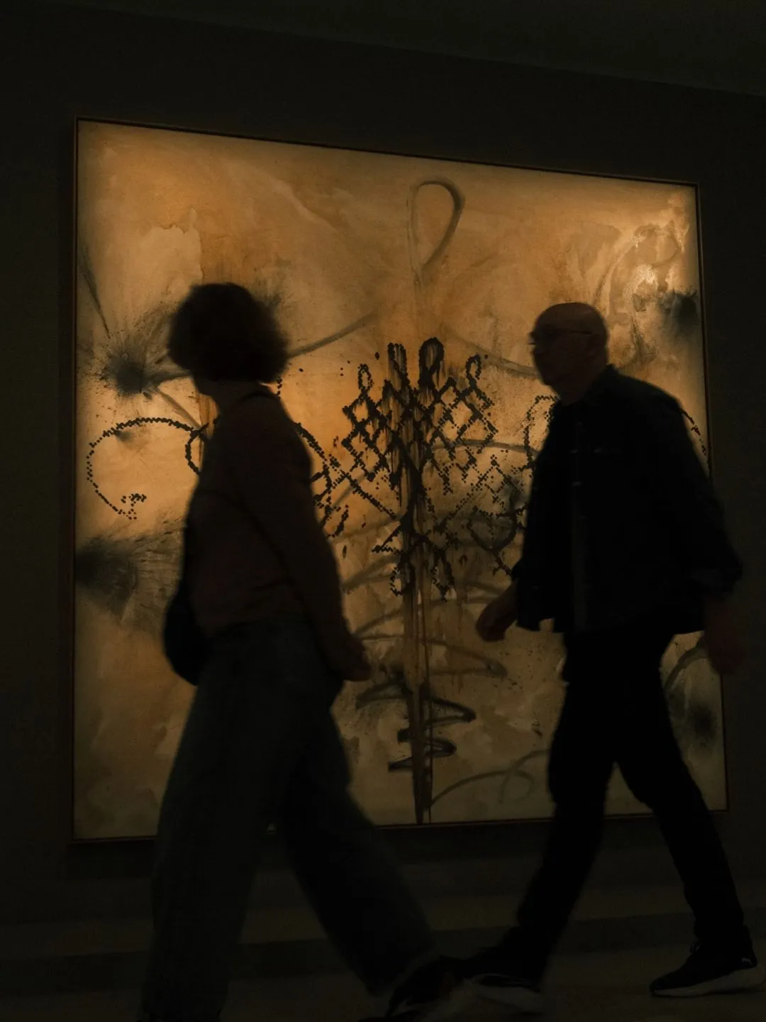 Two silhouettes inside Clair-obscur exhibition at the Bourse de Commerce, Pinault Collection, Paris.