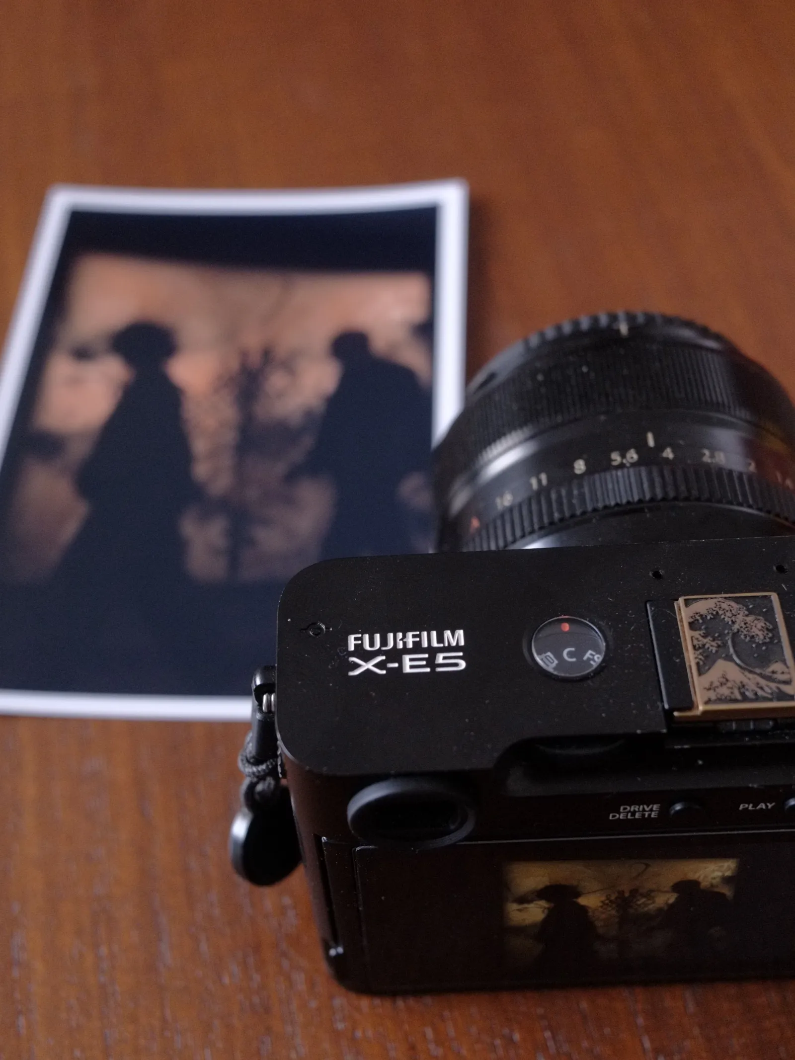 Fujifilm X-E5 and two silhouettes inside Clair-obscur exhibition at the Bourse de Commerce, Pinault Collection, Paris, printed on paper.