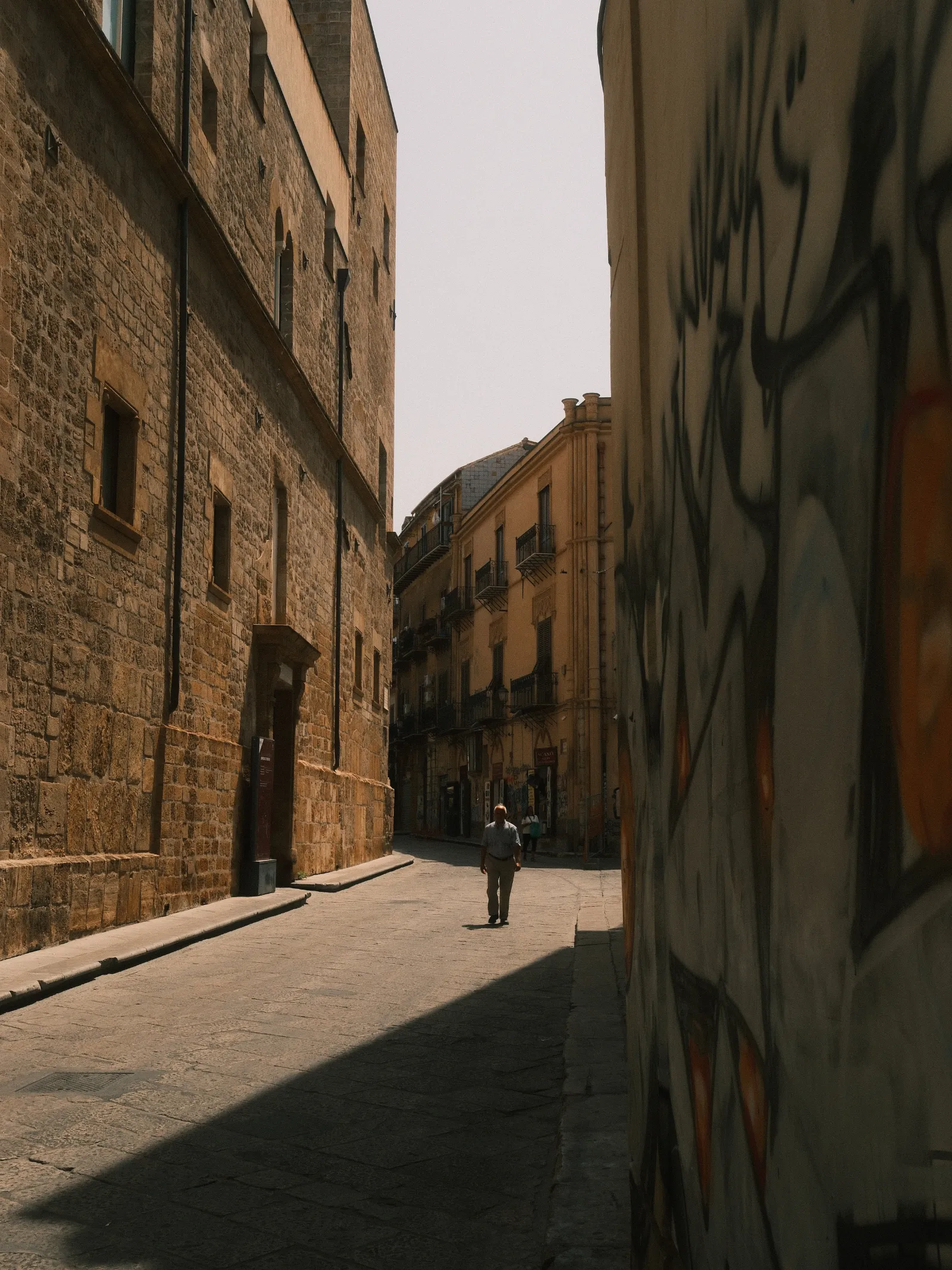 A man walking in the streets of Palermo