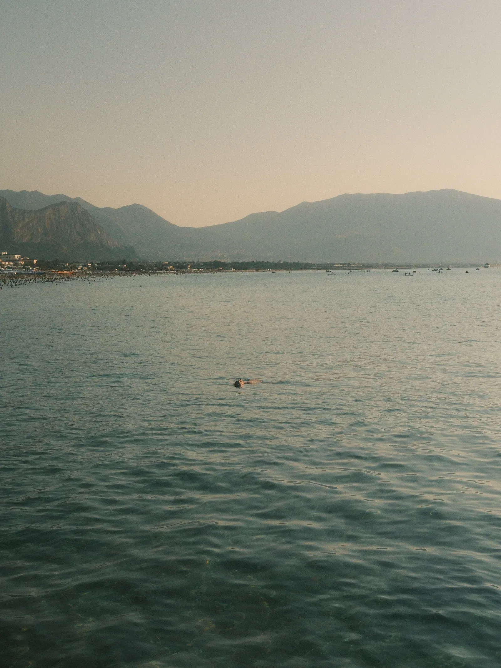 a man resting on water in Isola delle Femmine, Sicily