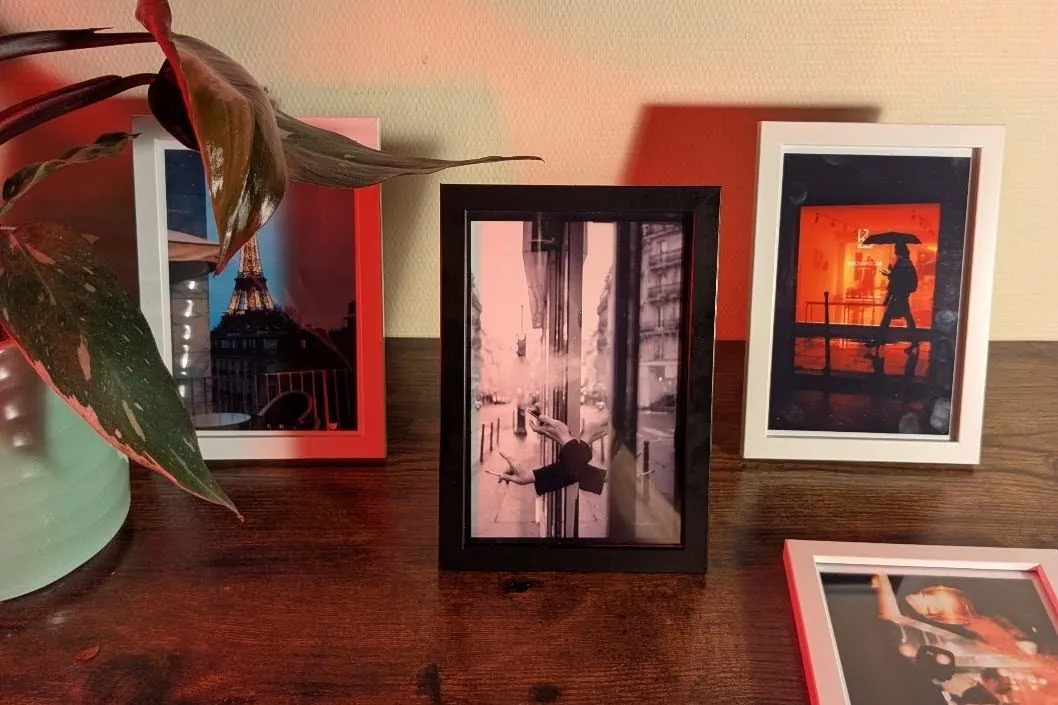 Photography prints on a desk.