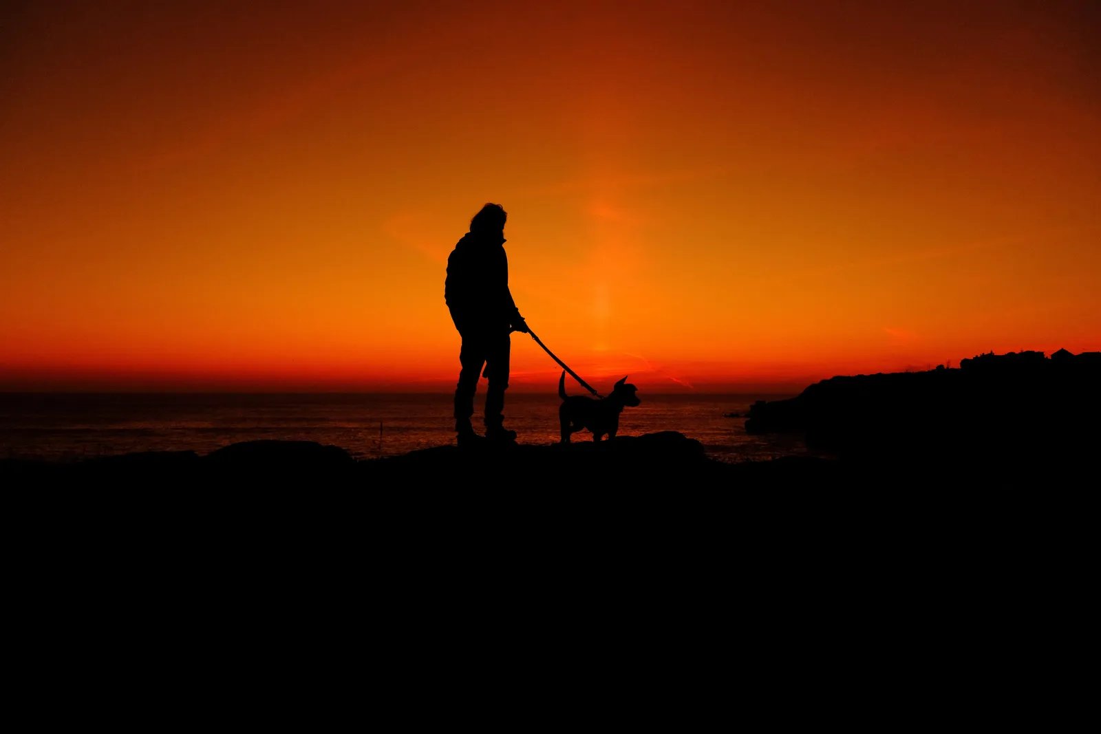 Silhouette and his dog during sunset in Peniche, taken on the Fujifilm X-E5 - SOOC jpeg only.